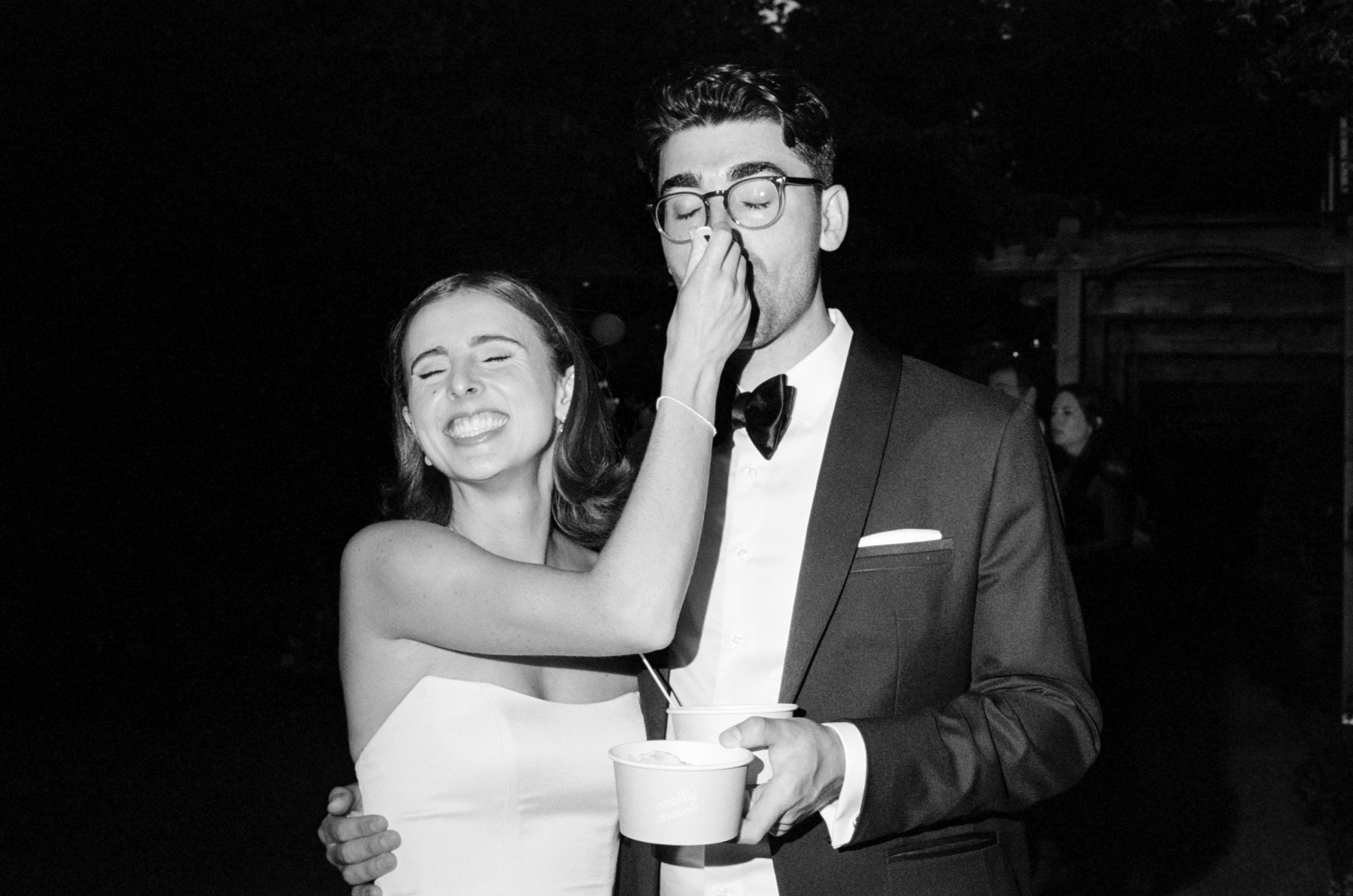 Bryan and Izzy sharing ice cream at their wedding